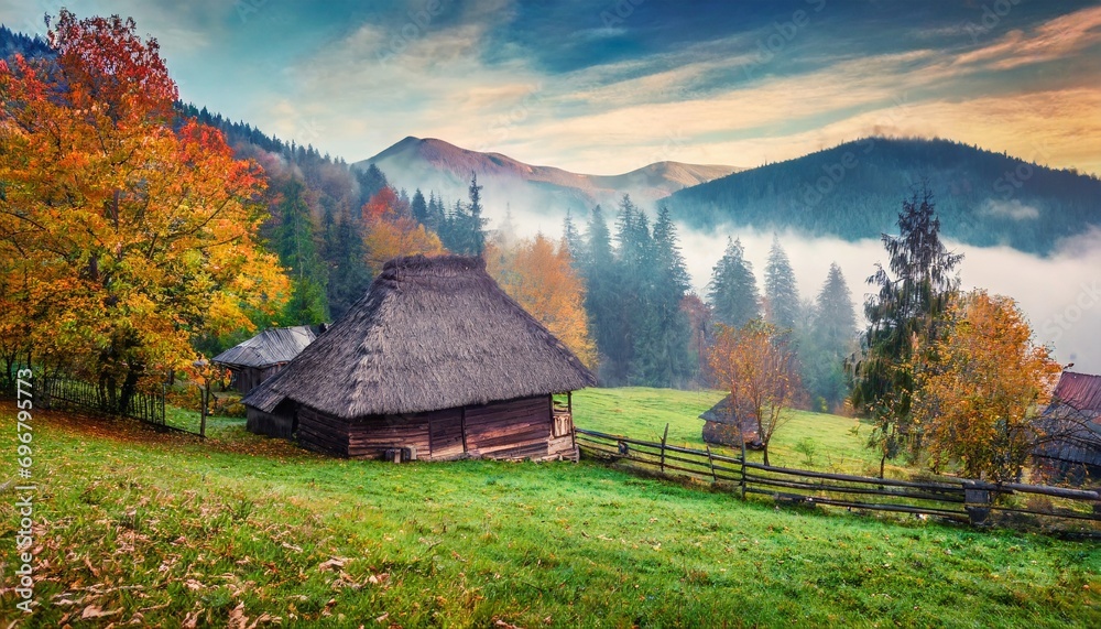 Wall mural foggy autumn scene of mountain willage with old wooden house in garden calm morning view of carpathian mountains ukraine europe beauty of countryside concept background