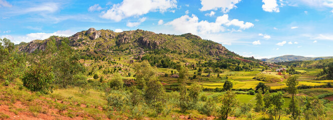 Typical Madagascar landscape in region near Tsiafahy, small hills covered with green grass and...