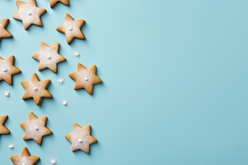 A delightful display of star-shaped cookies falling down a blue background