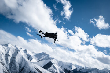 Fototapeta na wymiar Flying drone in high altitude snow mountains