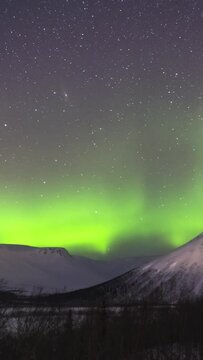 Snow-Capped Mountain, Stars and Northern Lights. Time Lapse. Vertical Video