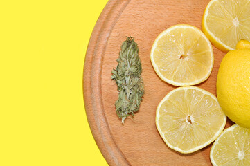 Lemon and cannabis on a wooden tray on a white background Medical cannabis Cannabis lemon flavor