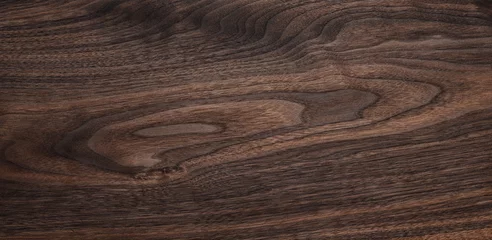Fototapeten Walnut texture background. Dark wooden plank desktop texture background. © Guiyuan