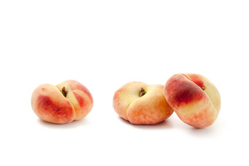 Three saturn peaches or flat peaches isolated on white background with clipping path..