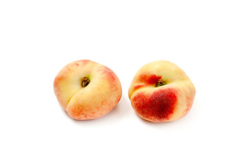 Naklejka na ściany i meble Two saturn peaches or flat peaches isolated on white background with clipping path..