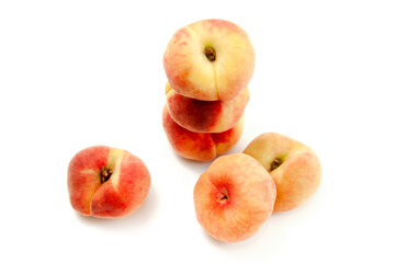 Several saturn peaches or flat peaches isolated on white background with clipping path.. © kostik2photo