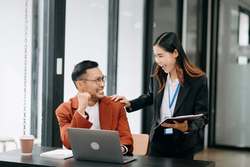 Female discussing new project with male colleague. Young woman talking with young man in office.