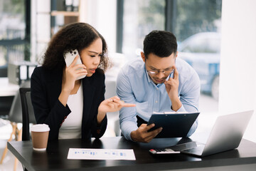 Business leading team meeting and using tablet and laptop with financial in office
