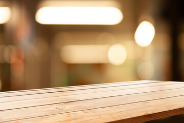 empty wooden brown table on blurred light gold bokeh cafe restaurant bar, place for your products...