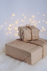 Christmas gift box on a white fur background with bokeh lights