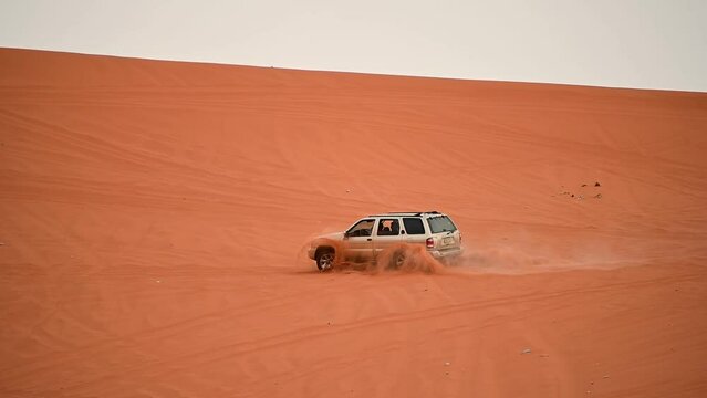 Riyadh, Saudi Arabia &ndash; November 1st 2023: Offroad vehicles bashing and climbing desert safari dunes ,red sand dunes adventurous ride 4x4 vehicle in Riyadh. Modified car, customized vehicle