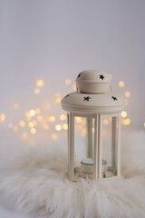 Christmas lantern with bokeh lights on white background. Festive decoration.