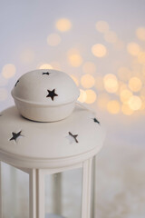Christmas lantern with bokeh lights on white background. Festive decoration.