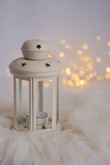 Christmas lantern with bokeh lights on white background. Festive decoration.