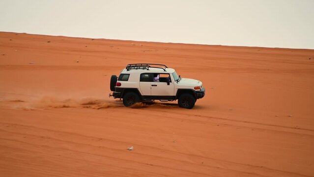 Riyadh, Saudi Arabia &ndash; November 1st 2023: Offroad vehicles bashing and climbing desert safari dunes ,red sand dunes adventurous ride 4x4 vehicle in Riyadh. Modified car, customized vehicle