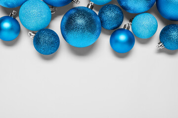 Light blue Christmas balls on white background, flat lay. Space for text