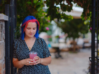 female summer old town walk in Antalya Turkey. Woman with colorful hair and dress strolls through...