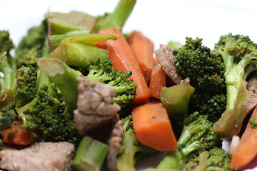 broccoli with meat and carrots. meal details. food with selective focus.