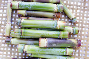 Fototapeta premium Fresh sugar cane on bamboo weave plate