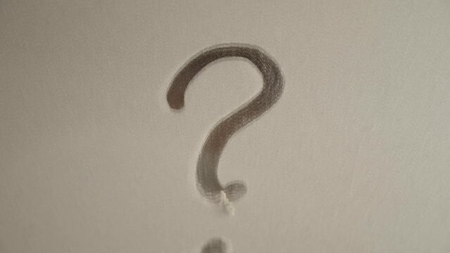 .A question mark is painted on the mirror contaminated with dust.