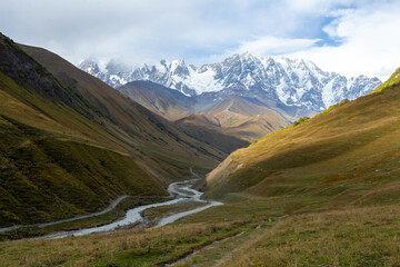 View of the mountain valley, Mount Shkhara at dawn.