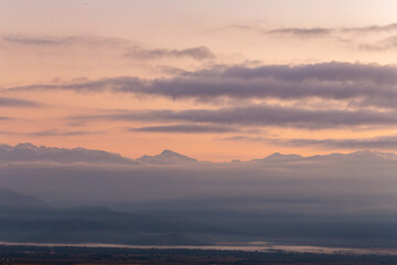 valley in the mountains at dawn in the fog
