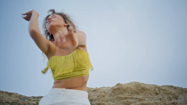 Expressive woman dancing sky performing modern choreography on nature close up. 