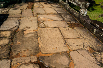 Carved stones with flower motifs, path towards Banteay Kdei temple in Angkor, Cambodia, Asia