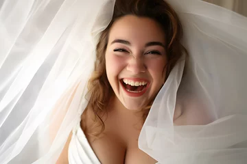 Fototapeten Laughing pretty curvy plus size bride in wedding dress © Firn