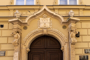 Decorative facade of medieval tenement house at Kanonicza Street, Krakow, Poland