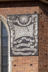 Facade of St. Mary's Church with sundial designed by Tadeusz Przypkowski, made with sgraffito technique, Krakow, Poland