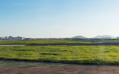 Fototapeta na wymiar Empty airport runway under blue sky
