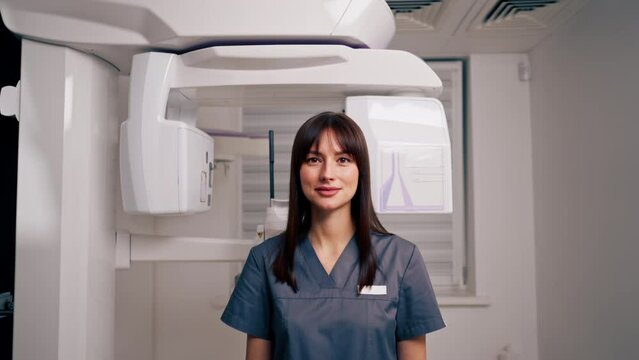 portrait of a beautiful young female doctor dentist or radiologist in uniform standing in the beauty and health clinic