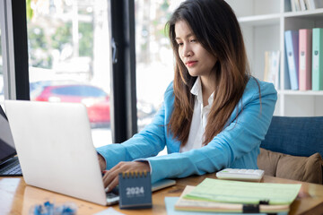 Business woman working in office with documents and laptop. Business concept