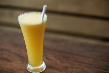 A Glass of Orange Juice with a Straw