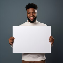 A man with a smile is holding a white board