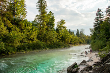 Landscape of Slovenia. The turquoise waters of the Soča River flow through the green forest