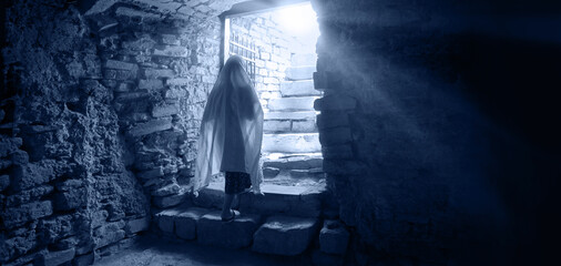 A person emerges from a dark dungeon