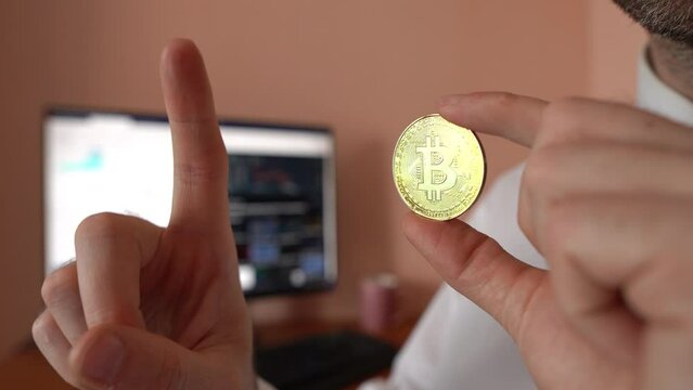 Office worker holds bitcoin and shows growth