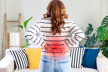 Young woman suffering from lower back pain - obrazy, fototapety, plakaty