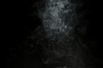 Abstract smoke misty fog on isolated black background. Texture overlays. Design element.