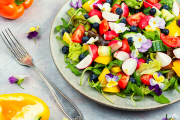 Spring salad with vegetables and flowers.