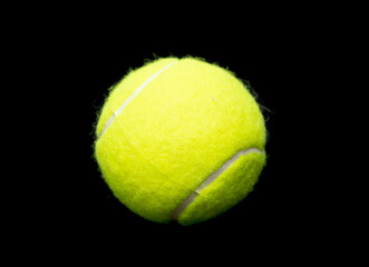 Yellow tennis ball on a black background.