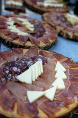 Italian hams and salami on a wooden chopping board