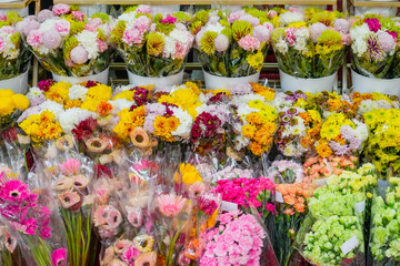Many lot bouquets compositions of flowers of various colored yellow red pink and white shades of chrysanthemum rose carnation flowers.