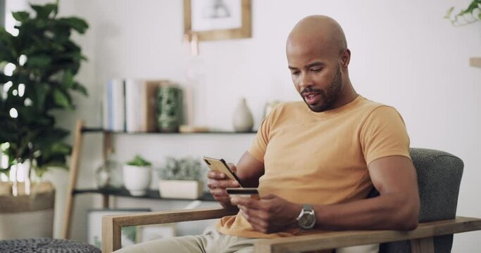 Man, phone and credit card on sofa with ecommerce for online shopping, fintech and internet payment in living room. Black person, smartphone and happy for web transaction or discount on sale website