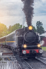 Retro steam train approaches to the platform.