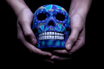 Traditional mexican skull made with clay and hand painted in vivid colors.