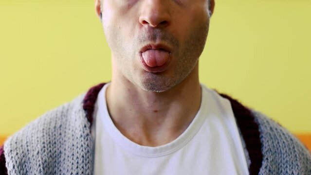 Detail of a man sticking his tongue out. Joke witty conceptual game close up 