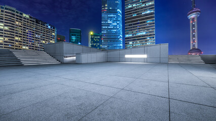 City square floor and modern building at night in Shanghai, China.
